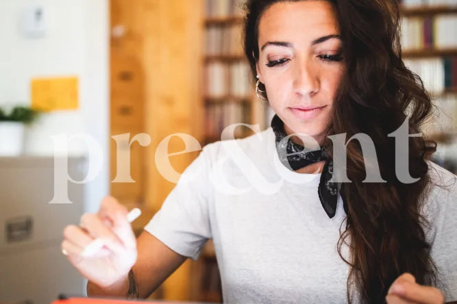 Person Working On A Tablet In Library