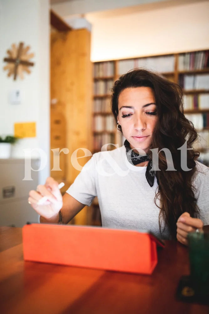 Person Working On A Tablet In Library