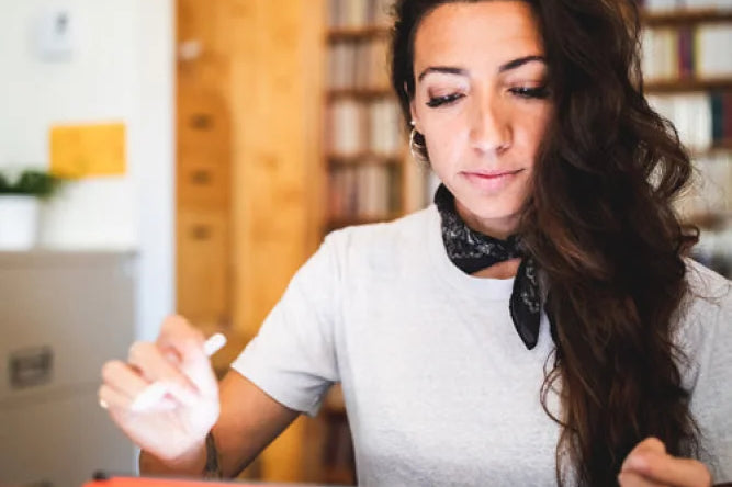 Person Working On A Tablet In Library