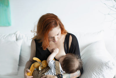 Baby tenderly breast feeding