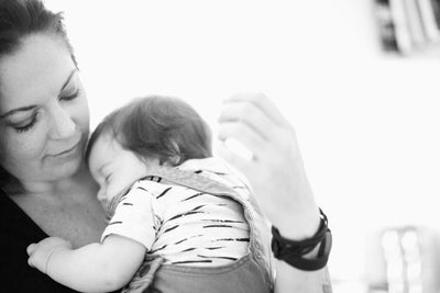 Baby sleeping in their parent's arms