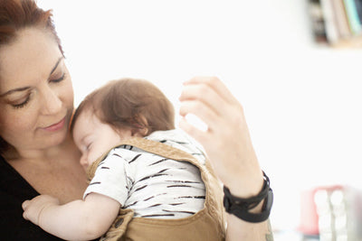 Baby sleeping in their parent's arms