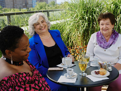 Three friends having coffee on a terrasse