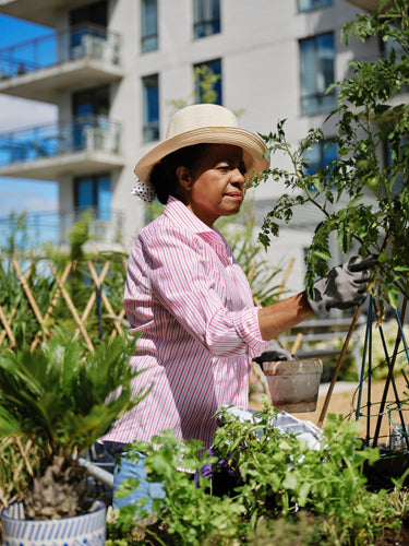 Green thumbs and hat at work